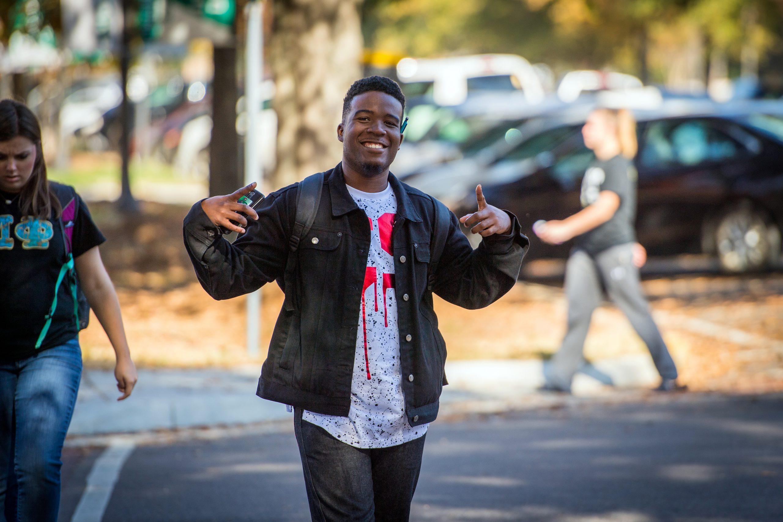 Student smiling and walking to class.